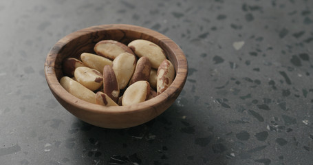 brazil nuts in olive bowl on terrazzo countertop