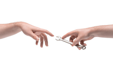 Two male hands passing one another a stainless steel wrench on white background