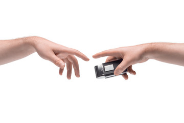 Two male hands passing one another small metallic shaver on white background