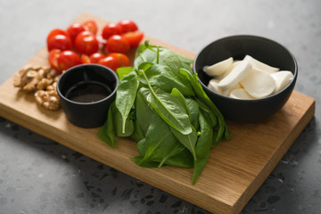 ingredients for salad, mozzarella, spinach and cherry tomatoes