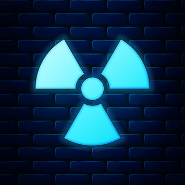 Glowing neon Radioactive icon isolated on brick wall background. Radioactive toxic symbol. Radiation Hazard sign. Vector Illustration