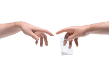 Two male hands passing one another small packet with drugs on white background