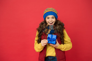 Feeling grateful. Holidays season. Happy childhood. Christmas gifts and souvenirs. Winter holidays. Happy kid in winter outfit red background. Pick some winter gifts for yourself. Wish list