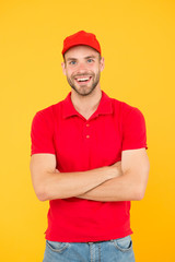 Courier and delivery service. Postman delivery worker. Man red cap yellow background. Delivering purchase. Already ready. Easing your business. Service delivery. Salesman and courier career
