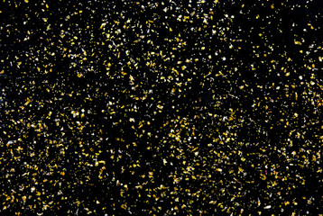 Golden glitter texture on black abstract background