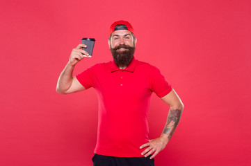Warmly. try take away coffee. best quality of cafe waiter. good morning coffee to go. energy concept. bearded man drink from paper cup. brutal hipster red uniform. happy barista fresh coffee