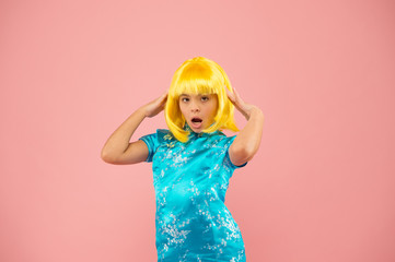 Girl yellow wig. Cosplay character concept. Japanese style. Eastern trends for teens. Hobby and entertainment. Pop culture. Anime fan. Child cute cosplayer. Anime emotional expression. Anime admirer