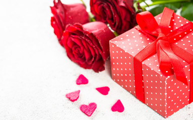 Valentines day background. Red roses, hearts and present on white.