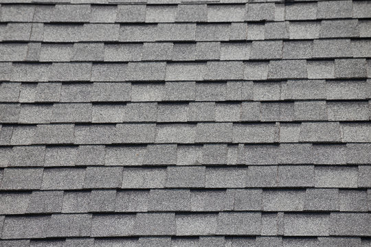 Roof shingles background and texture. grey and black asphalt tile of house roof.