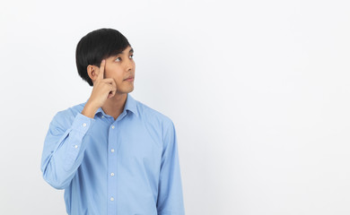 Young handsome asian business man thinking an idea while looking up isolated on white background.