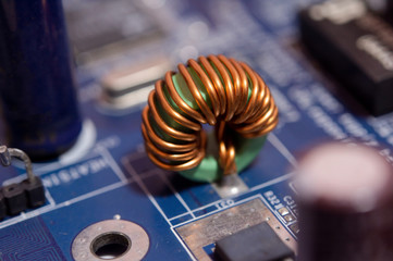 Close up Inductor electronic hardware technology on motherboard digital chip.