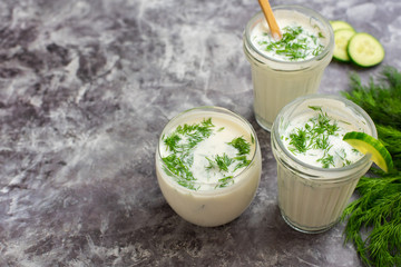Smoothies of kefir, dill and cucumbers, on the gray background