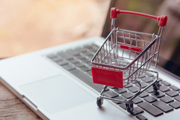 Shopping online concept - Empty shopping cart or trolley on a laptop keyboard. Shopping service on The online web. offers home delivery..