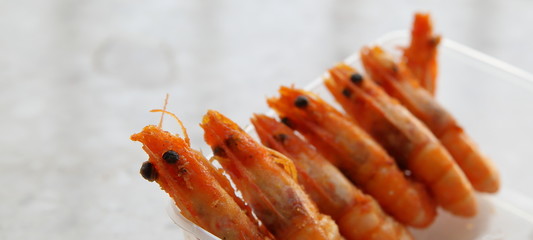 Cooked shrimps on a plate, isolated, close up