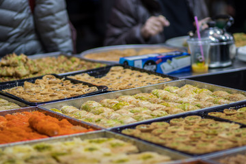 Baklava (modern Middle Eastern Arab-style dessert) baked with sugar and honey syrup, sweet and stuffed with almonds, nuts, chocolate or pistachios. In the old market, Jerusalem.