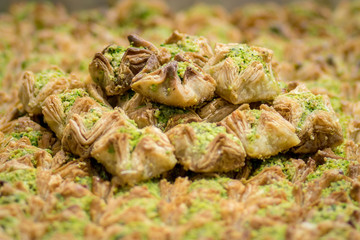 Baklava (modern Middle Eastern Arab-style dessert) baked with sugar and honey syrup, sweet and stuffed with almonds, nuts, chocolate or pistachios. In the old market, Jerusalem.