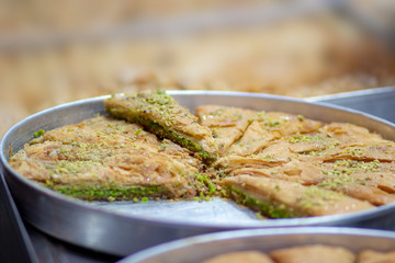 Baklava (modern Middle Eastern Arab-style dessert) baked with sugar and honey syrup, sweet and stuffed with almonds, nuts, chocolate or pistachios. In the old market, Jerusalem.