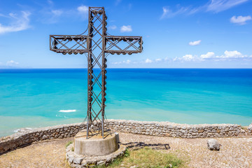 Cross on a Cefalu Rock - large massif above Cefalu city located on the shore of Tyrrhenian Sea on...