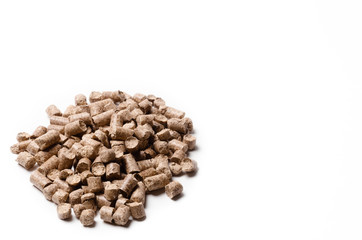 Pressed wood filler granules absorb odor, for pet toilet. Pressed wood pellets as an alternative fuel. isolate on a white background. 
