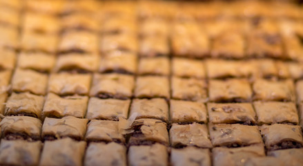 Baklava (modern Middle Eastern Arab-style dessert) baked with sugar and honey syrup, sweet and stuffed with almonds, nuts, chocolate or pistachios. In the old market, Jerusalem.