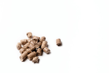 Pressed wood filler granules absorb odor, for pet toilet. Pressed wood pellets as an alternative fuel. isolate on a white background. 