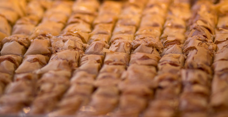 Baklava (modern Middle Eastern Arab-style dessert) baked with sugar and honey syrup, sweet and stuffed with almonds, nuts, chocolate or pistachios. In the old market, Jerusalem.