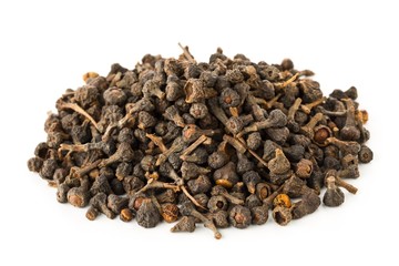 Heap of raw, dried cinnamon blossom buds spice over white