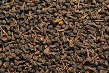 Raw, dried cinnamon blossom buds spice top view flat lay frame filling background