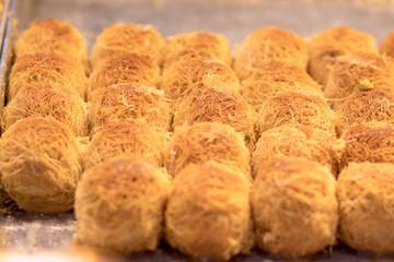 Baklava (modern Middle Eastern Arab-style dessert) baked with sugar and honey syrup, sweet and stuffed with almonds, nuts, chocolate or pistachios. In the old market, Jerusalem.