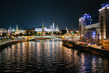 Fototapeta na wymiar MOSCOW, RUSSIA - AUGUST, 2019: Moscow Kremlin and bridge through Moscow River at night