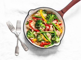 Vegetarian vegetable paella in a cooking pan on a light background, top view
