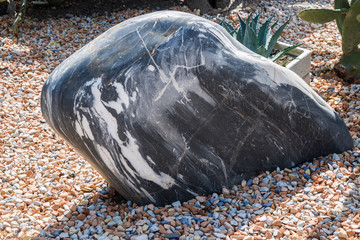 Structure of natural stones close-up. The stones are piled high.
