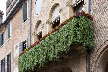 Balcony with ivy and plaque in memory of the residence in August 1866 of Prince Amedeo of Savoy, Duke of Aosta, Padua, Italy.