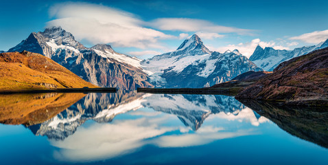 Obraz na płótnie Canvas Panoramic morning view of Bachalp lake / Bachalpsee, Switzerland. Majestic autumn scene of Swiss alps, Grindelwald, Bernese Oberland, Europe. Beauty of nature concept background.
