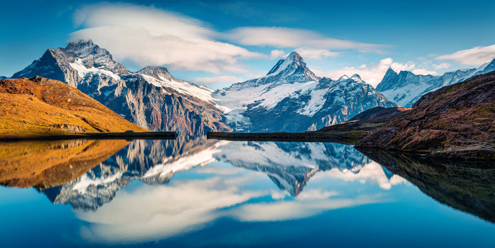 Panoramic morning view of Bachalp lake / Bachalpsee, Switzerland. Majestic autumn scene of Swiss alps, Grindelwald, Bernese Oberland, Europe. Beauty of nature concept background. © Andrew Mayovskyy
