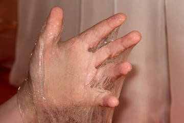 The child's hand is smeared with white slime