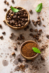 Coffee background. Coffee beans and ground powder on a stone concrete tabletop.