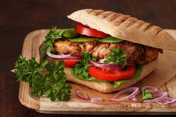 Healthy Grilled Chicken Sandwich with tomatoes, onions and lettuce