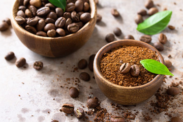 Coffee background. Coffee beans and ground powder on a stone concrete tabletop. Copy space.