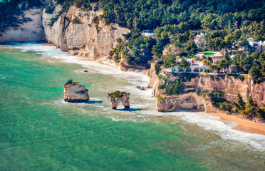 Aerial summer view of popular scenic spot - Faraglioni Di Puglia and Faragliony beach, Apulia...