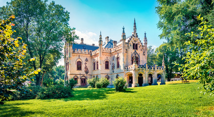 Fototapeta na wymiar Bright morning view of Sturdza castle. Picturesque summer scene of the green park in Miclauseni monastery. Colorful landscape of Romania, Europe. Traveling concept background.