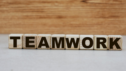 Fototapeta na wymiar concept word teamwork on cubes on a wooden background