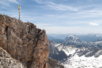 cross on the summit of the zugspitze on snow covered mountains