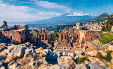 Superb morning view of Taormina town and Etna volcano on background. Spectacular spring view of...