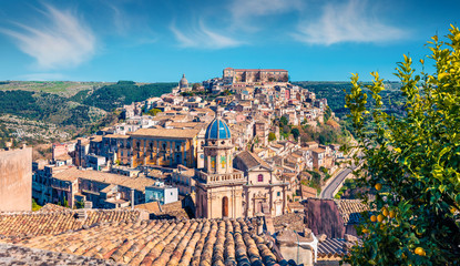 Sunny spring cityscape of Ragusa town with Palazzo Cosentini and Duomo di San Giorgio church on...