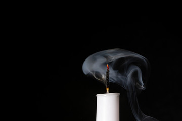 Extinguished Flame from Candle on Black Background