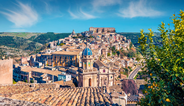 Sunny spring cityscape of Ragusa town with Palazzo Cosentini and Duomo di San Giorgio church on background. Nice afternoon scene of Sicily, Italy, Europe. Traveling concept background.