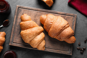 Flat lay composition with tasty croissants on grey table