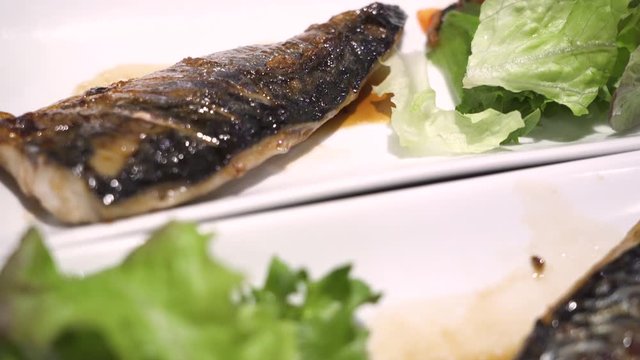 4k close up grilled saba fish, Japanese recipe menu, lunch time, Asian cuisine, nutrition diet, omega 3, fluorescent light, green vegetable, meal course dinner, indoor restaurant, pan down movement