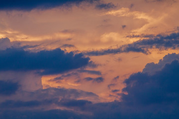 Fototapeta na wymiar Dawn sky with dark clouds illuminated by the sun.